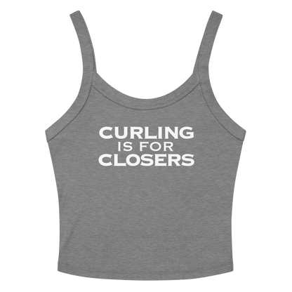"Curling Is For Closers" printed on a athletic heather women's micro-rib tanktop laying on a flat surface amongst sunglasses and shorts