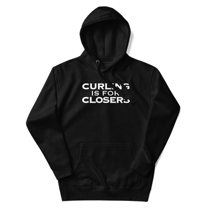 "Curling Is For Closers" printed on a black unisex hoodie laying on a flat surface with the hood up