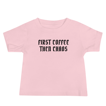 "First Coffee  Then Chaos" printed on a pink baby jersey short sleeve tee laying on a flat surface