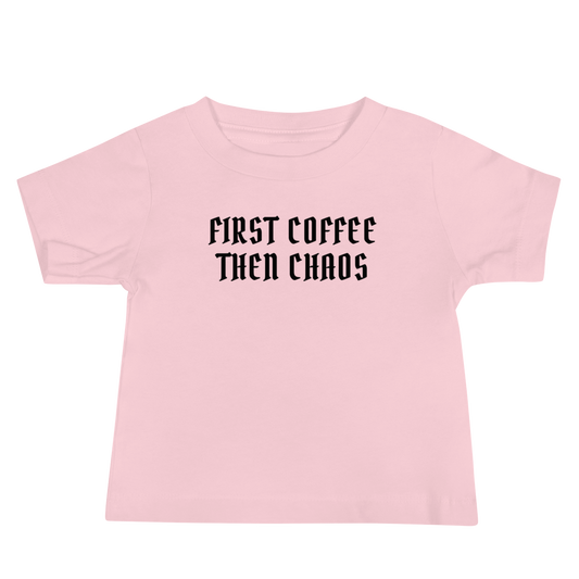 "First Coffee  Then Chaos" printed on a pink baby jersey short sleeve tee laying on a flat surface