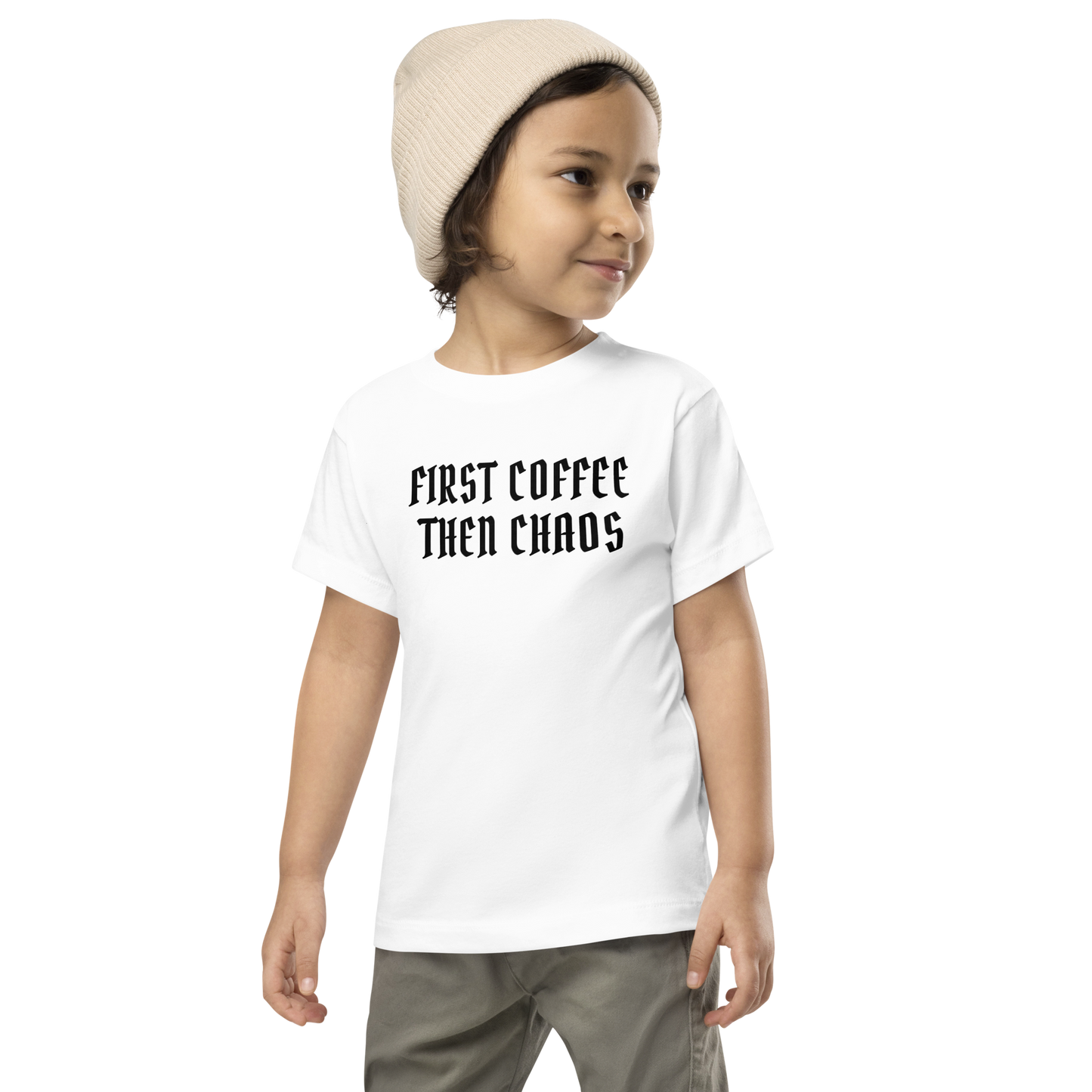 "First Coffee  Then Chaos" printed on a white toddler short sleeve tee worn by a male wearing a cap