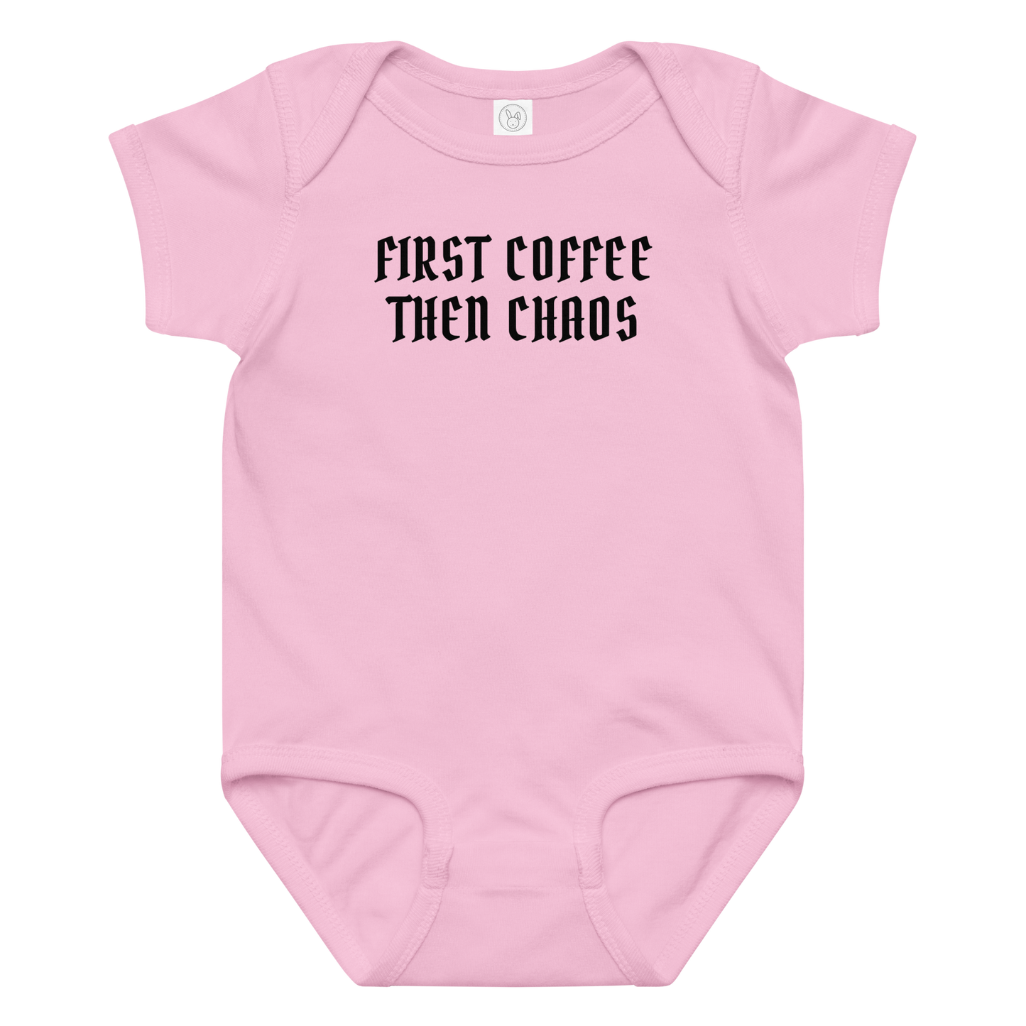 "First Coffee  Then Chaos" printed on a pink baby jersey bodysuit laying on a flat surface amongst other clothes