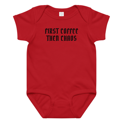 "First Coffee  Then Chaos" printed on a red baby jersey bodysuit laying on a flat surface amongst other clothes