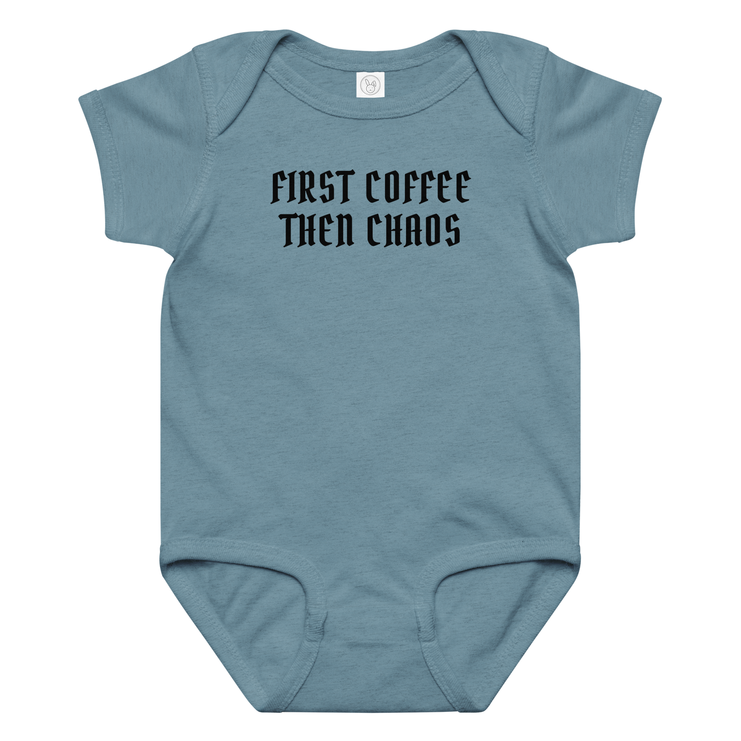 "First Coffee  Then Chaos" printed on a vintage indigo baby jersey bodysuit laying on a flat surface amongst other clothes