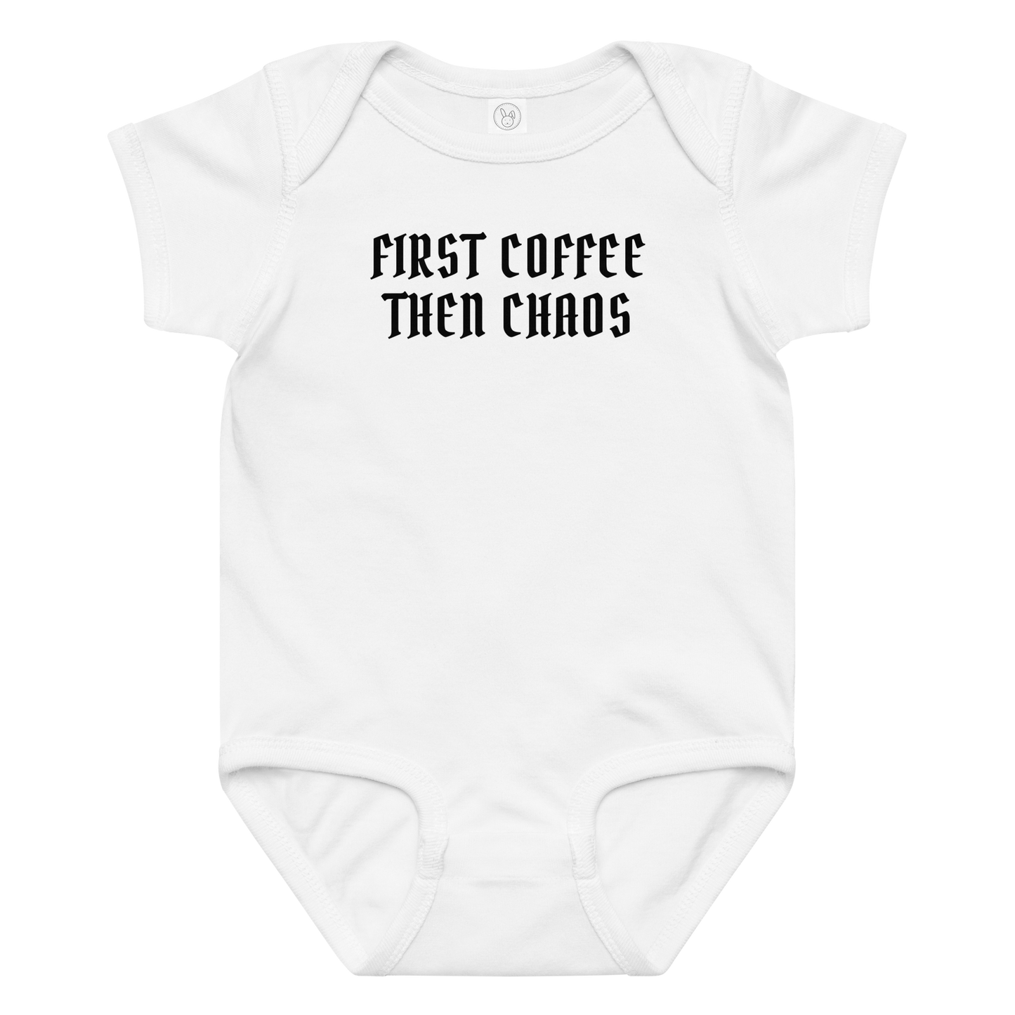 "First Coffee  Then Chaos" printed on a white baby jersey bodysuit laying on a flat surface amongst other clothes