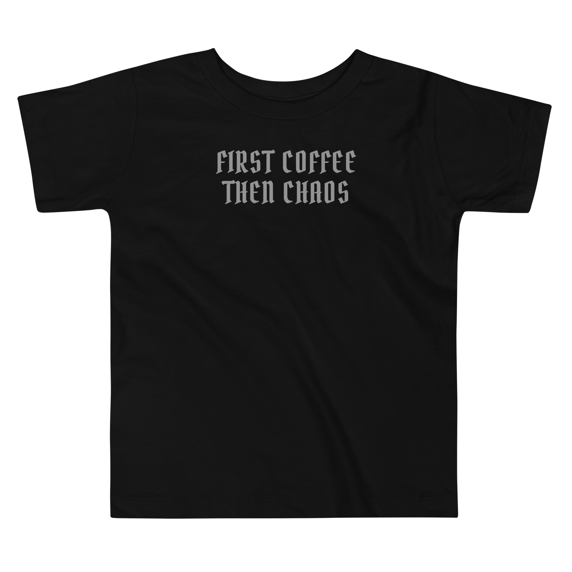 "First Coffee  Then Chaos" printed on a black toddler short sleeve tee laying on a flat surface