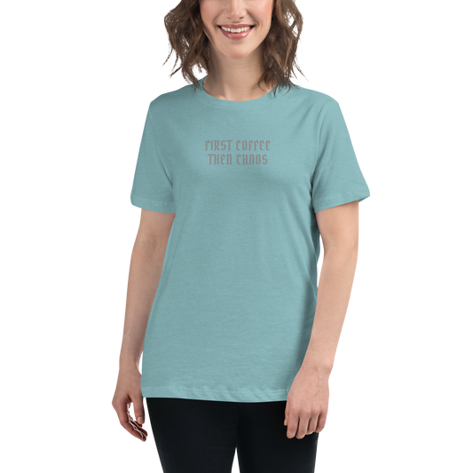 "First Coffee  Then Chaos" printed on a heather blue lagoon women's relaxed t-shirt worn by a female