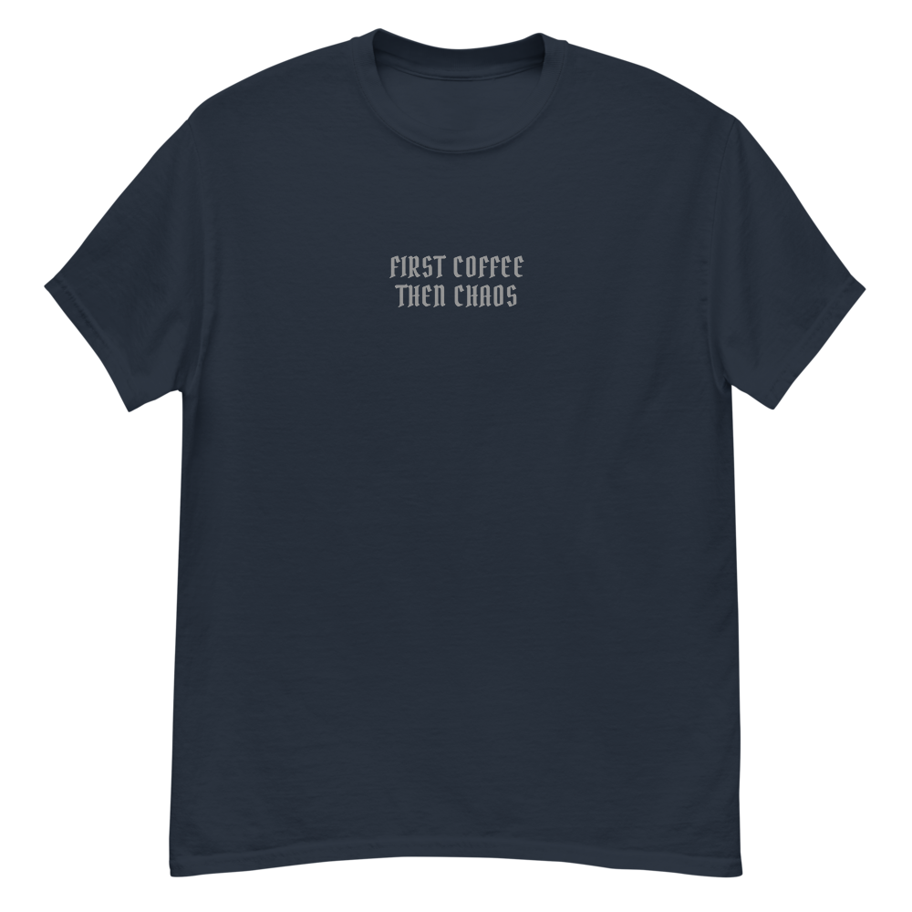 "First Coffee  Then Chaos" printed on a navy unisex classic tee laying on a flat surface