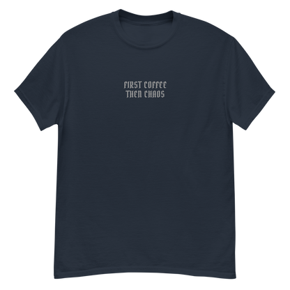 "First Coffee  Then Chaos" printed on a navy unisex classic tee laying on a flat surface