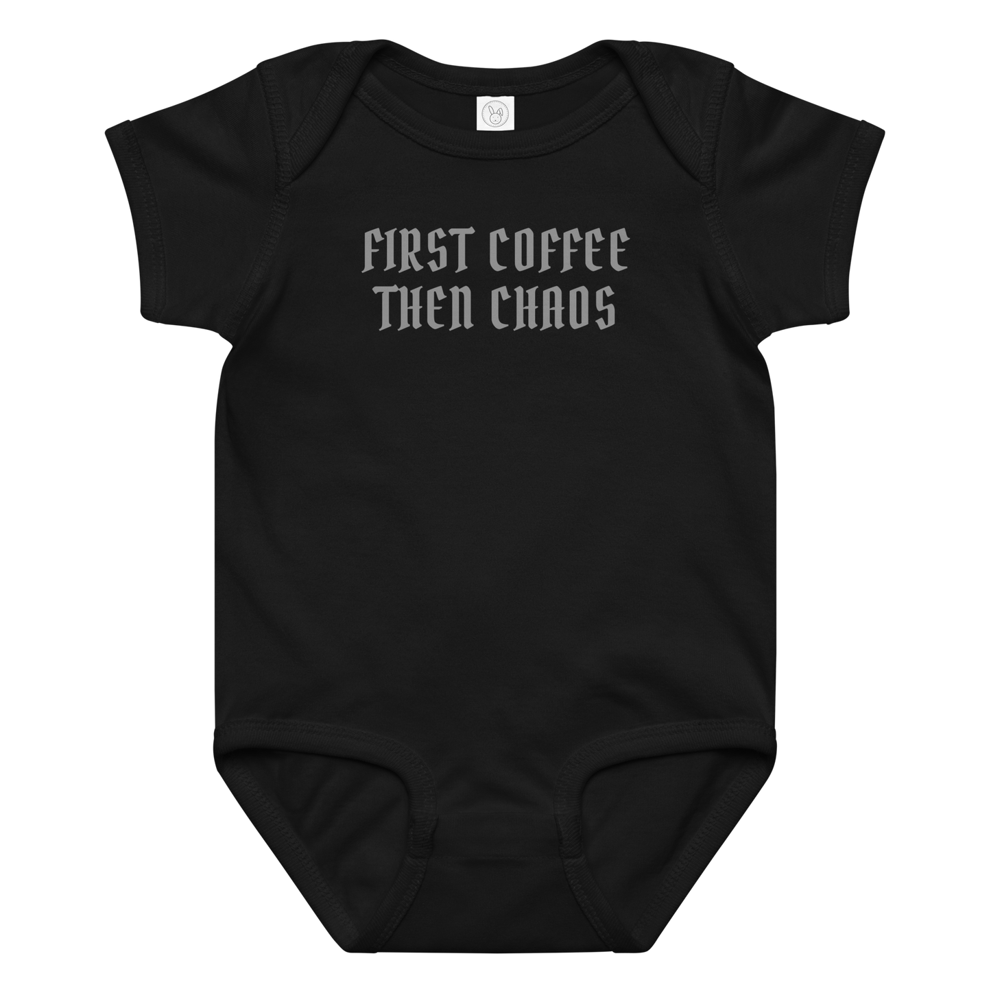 "First Coffee  Then Chaos" printed on a black baby jersey bodysuit laying on a flat surface amongst other clothes