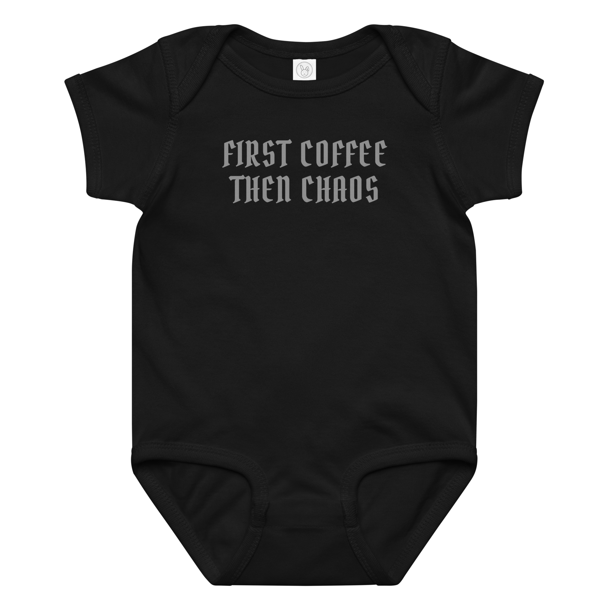 "First Coffee  Then Chaos" printed on a black baby jersey bodysuit laying on a flat surface amongst other clothes