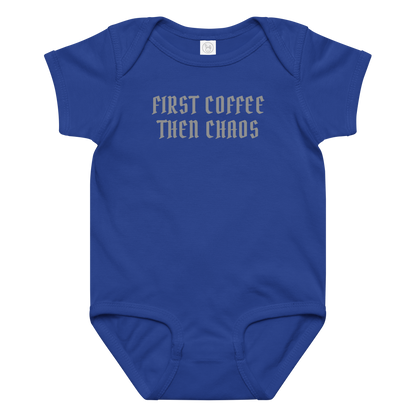 "First Coffee  Then Chaos" printed on a royal baby jersey bodysuit laying on a flat surface amongst other clothes