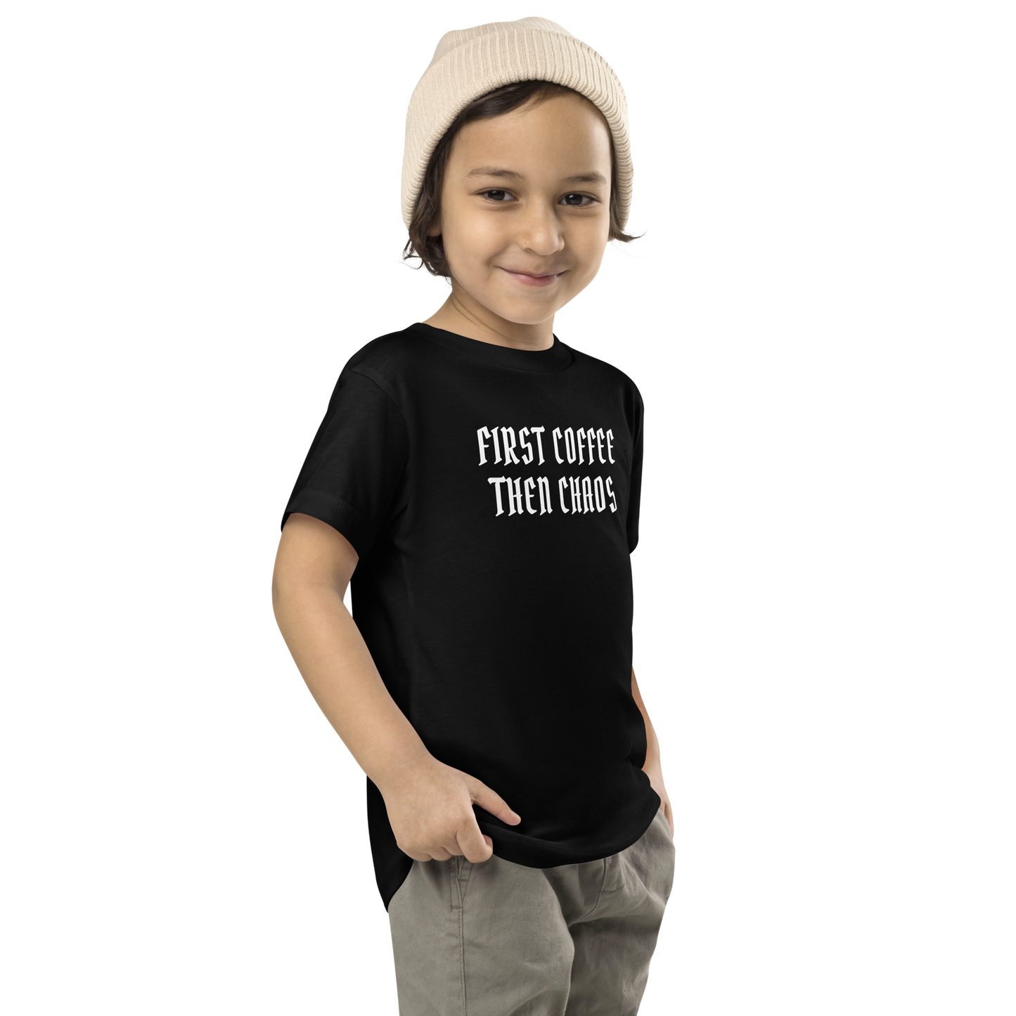 "First Coffee  Then Chaos" printed on a black toddler short sleeve tee worn by a male who is also wearing a knit cap