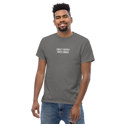 "First Coffee  Then Chaos" printed on a charcoal unisex classic tee worn by a male