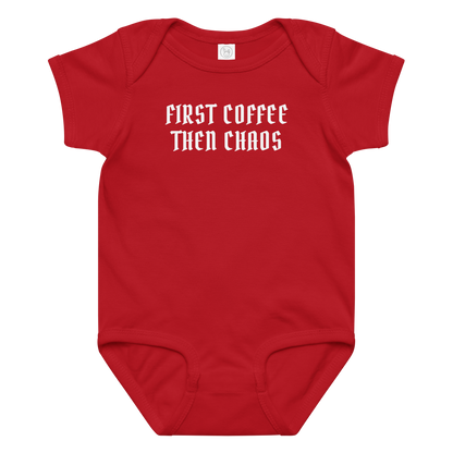 "First Coffee  Then Chaos" printed on a red baby jersey bodysuit laying on a flat surface amongst other clothes