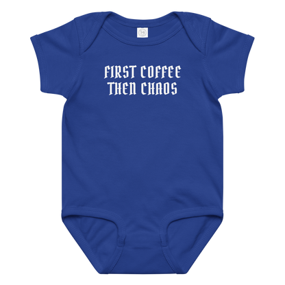"First Coffee  Then Chaos" printed on a royal baby jersey bodysuit laying on a flat surface amongst other clothes