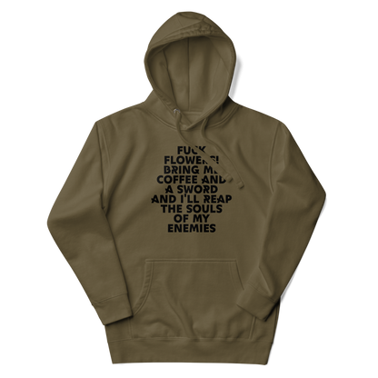 "Fuck Flowers! Bring Me Coffee And A Sword And I'll Reap The Souls Of My Enemies" printed on a military green unisex hoodie laying on a flat surface with the hood up