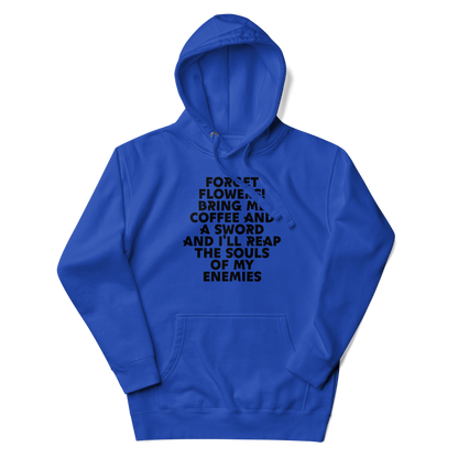 "Forget Flowers! Bring Me Coffee And A Sword And I'll Reap The Souls Of My Enemies" printed on a team royal unisex hoodie laying on a flat surface with the hood up