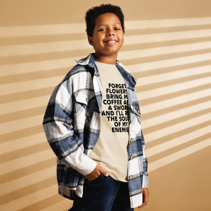 "Forget Flowers! Bring Me Coffee And A Sword And I'll Reap The Souls Of My Enemies" printed on a natural youth classic tee worn by a male also wearing a jacket