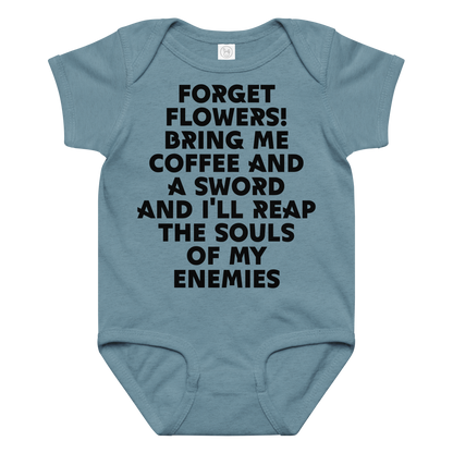 "Forget Flowers! Bring Me Coffee And A Sword And I'll Reap The Souls Of My Enemies" printed on a vintage indigo baby jersey bodysuit laying on a flat surface amongst other clothes