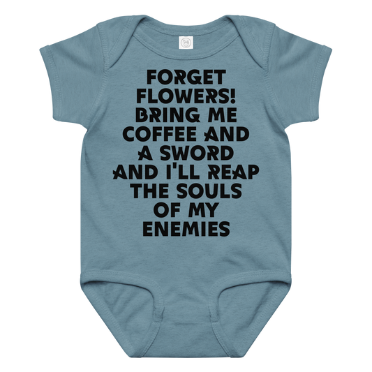 "Forget Flowers! Bring Me Coffee And A Sword And I'll Reap The Souls Of My Enemies" printed on a vintage indigo baby jersey bodysuit laying on a flat surface amongst other clothes