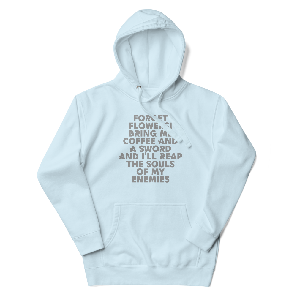 "Forget Flowers! Bring Me Coffee And A Sword And I'll Reap The Souls Of My Enemies" printed on a sky blue unisex hoodie laying on a flat surface with the hood up