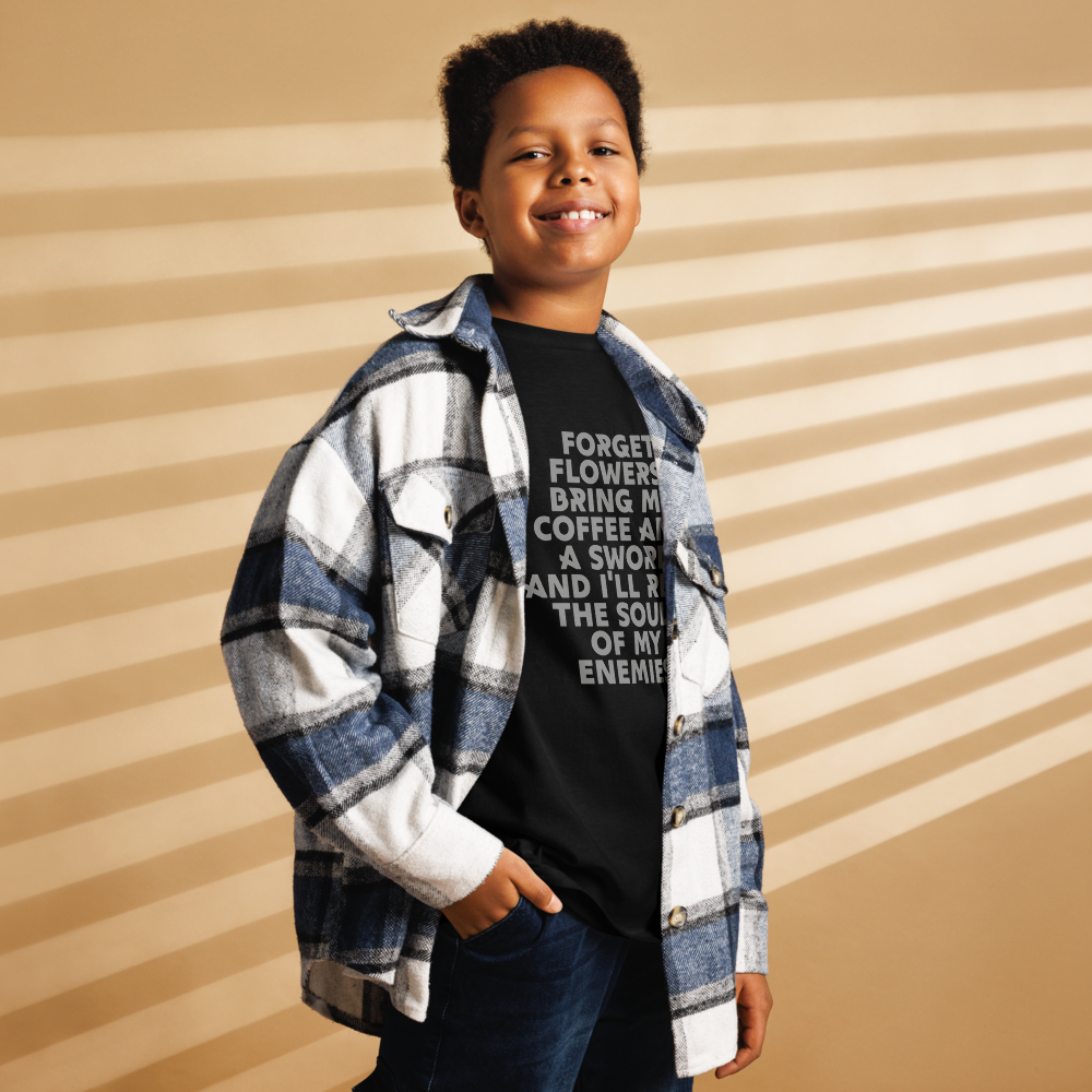 "Forget Flowers! Bring Me Coffee And A Sword And I'll Reap The Souls Of My Enemies" printed on a black youth classic tee worn by a male also wearing a jacket