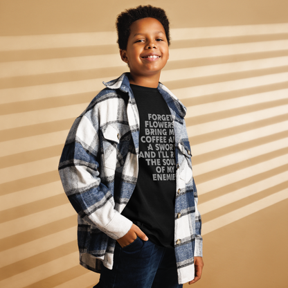 "Forget Flowers! Bring Me Coffee And A Sword And I'll Reap The Souls Of My Enemies" printed on a black youth classic tee worn by a male also wearing a jacket