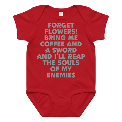 "Forget Flowers! Bring Me Coffee And A Sword And I'll Reap The Souls Of My Enemies" printed on a red baby jersey bodysuit laying on a flat surface amongst other clothes