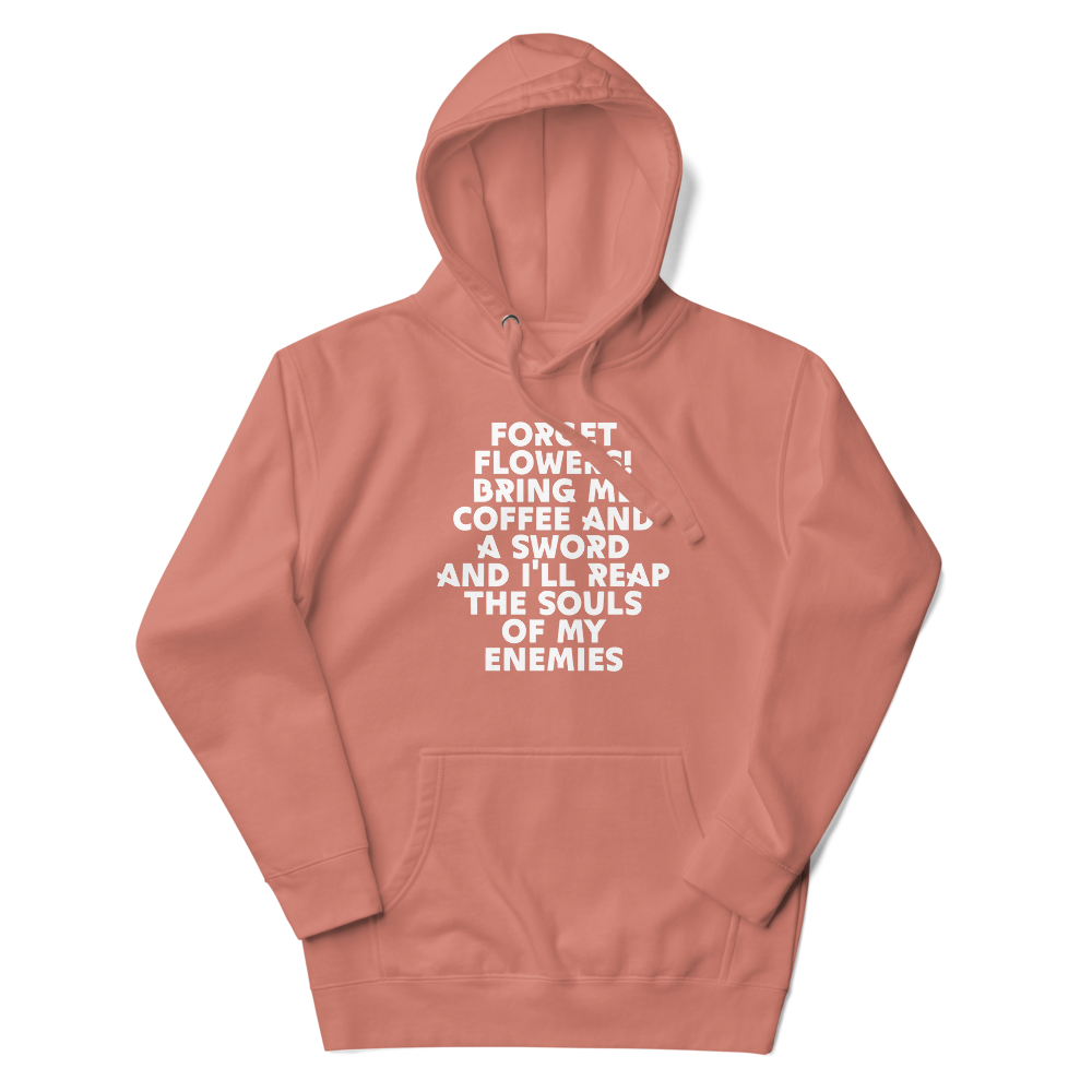 "Forget Flowers! Bring Me Coffee And A Sword And I'll Reap The Souls Of My Enemies" printed on a dusty rose unisex hoodie laying on a flat surface with the hood up