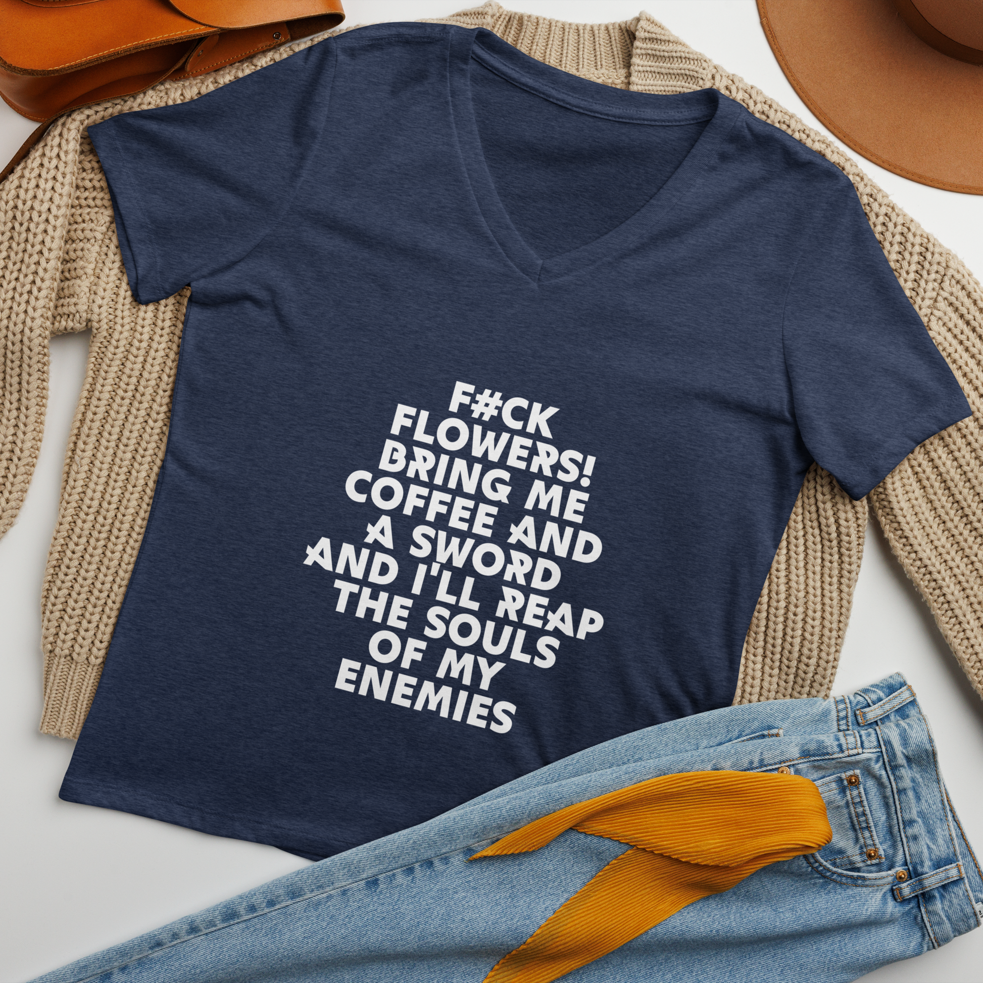 "F#Ck Flowers! Bring Me Coffee And A Sword And I'll Reap The Souls Of My Enemies" printed on a heather navy women's relaxed v-neck t-shirt laying on a flat surface amongst other clothes