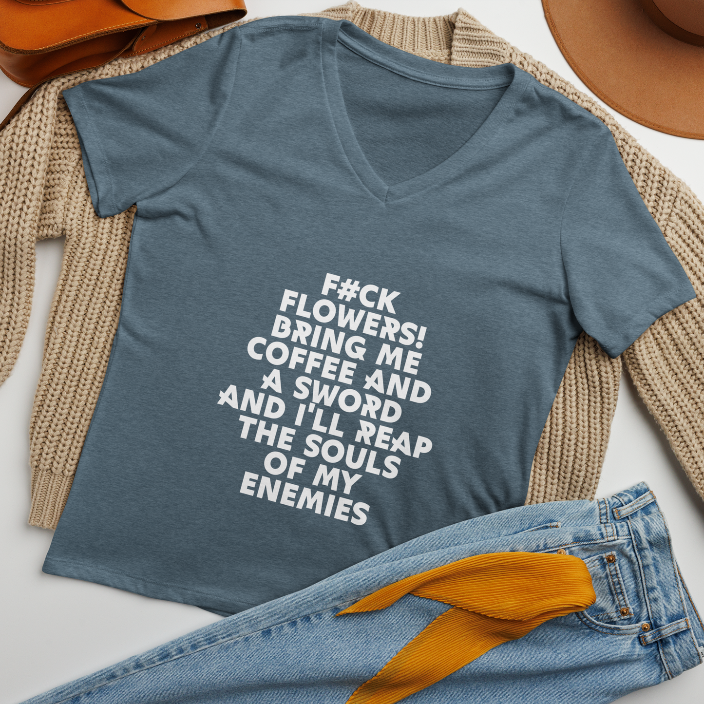"F#Ck Flowers! Bring Me Coffee And A Sword And I'll Reap The Souls Of My Enemies" printed on a heather slate women's relaxed v-neck t-shirt laying on a flat surface amongst other clothes