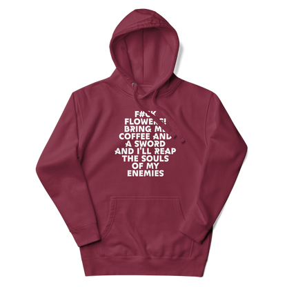 "F#Ck Flowers! Bring Me Coffee And A Sword And I'll Reap The Souls Of My Enemies" printed on a maroon unisex hoodie laying on a flat surface with the hood up