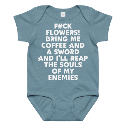 "F#Ck Flowers! Bring Me Coffee And A Sword And I'll Reap The Souls Of My Enemies" printed on a vintage indigo baby jersey bodysuit laying on a flat surface amongst other clothes