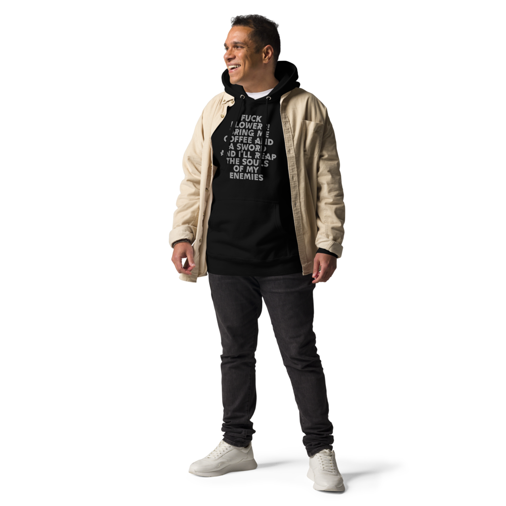 "Fuck Flowers! Bring Me Coffee And A Sword And I'll Reap The Souls Of My Enemies" printed on a black unisex hoodie worn by a male with a jacket on top