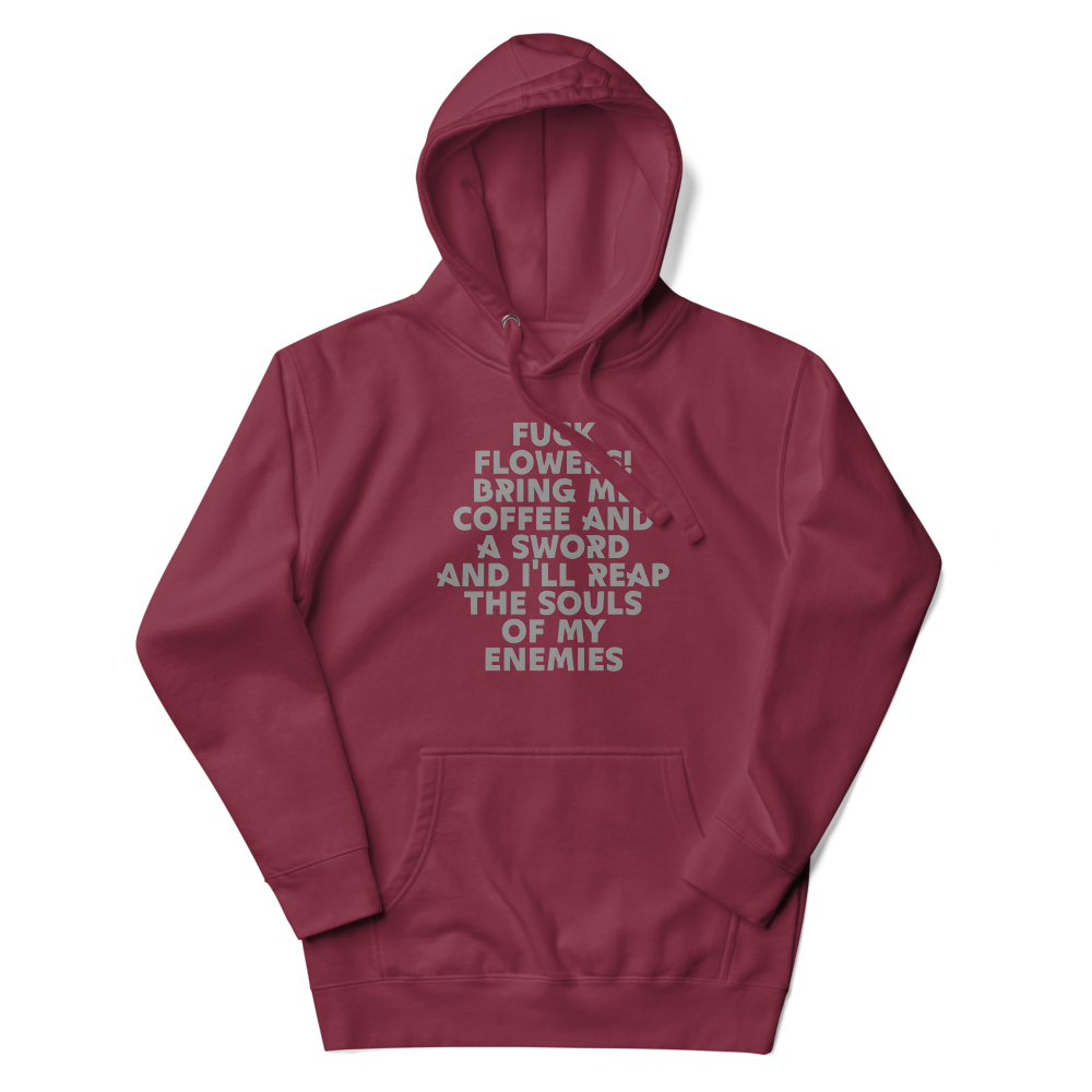 "Fuck Flowers! Bring Me Coffee And A Sword And I'll Reap The Souls Of My Enemies" printed on a maroon unisex hoodie laying on a flat surface with the hood up