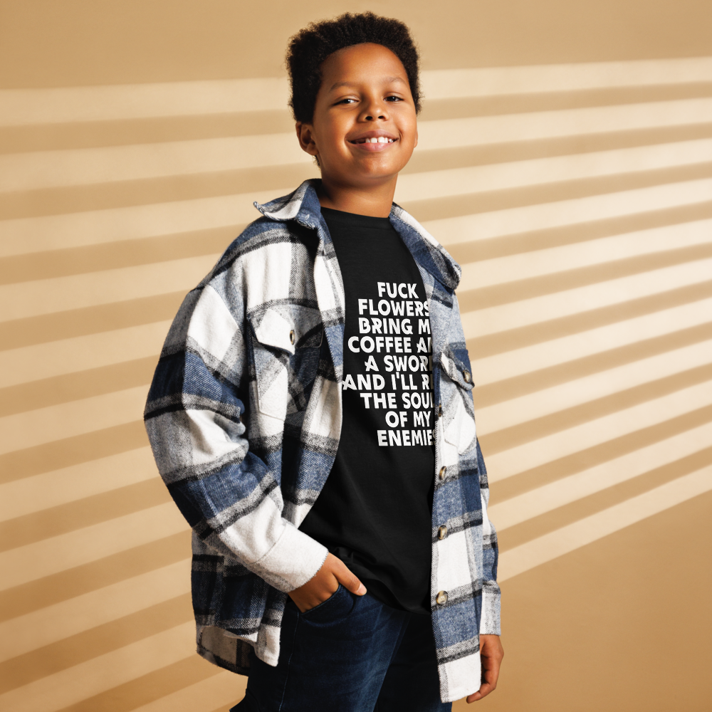 "Fuck Flowers! Bring Me Coffee And A Sword And I'll Reap The Souls Of My Enemies" printed on a black youth classic tee worn by a male also wearing a jacket