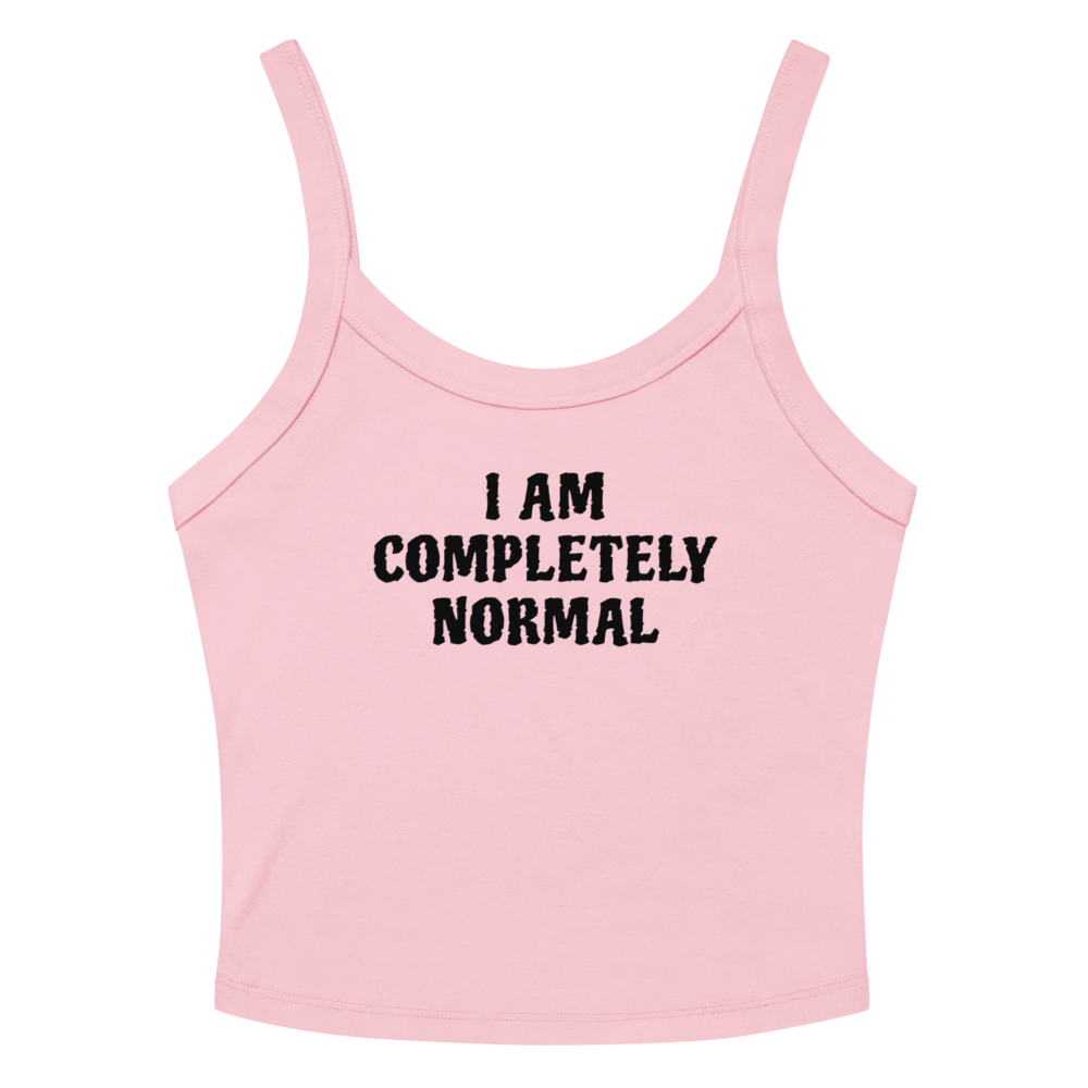 "I am completely normal" printed on a solid pink blend women's micro-rib tanktop laying on a flat surface amongst sunglasses and shorts