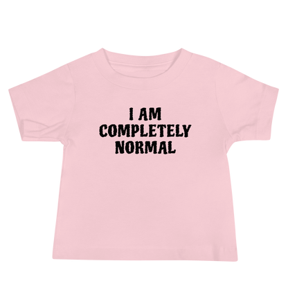 "I am completely normal" printed on a pink baby jersey short sleeve tee laying on a flat surface