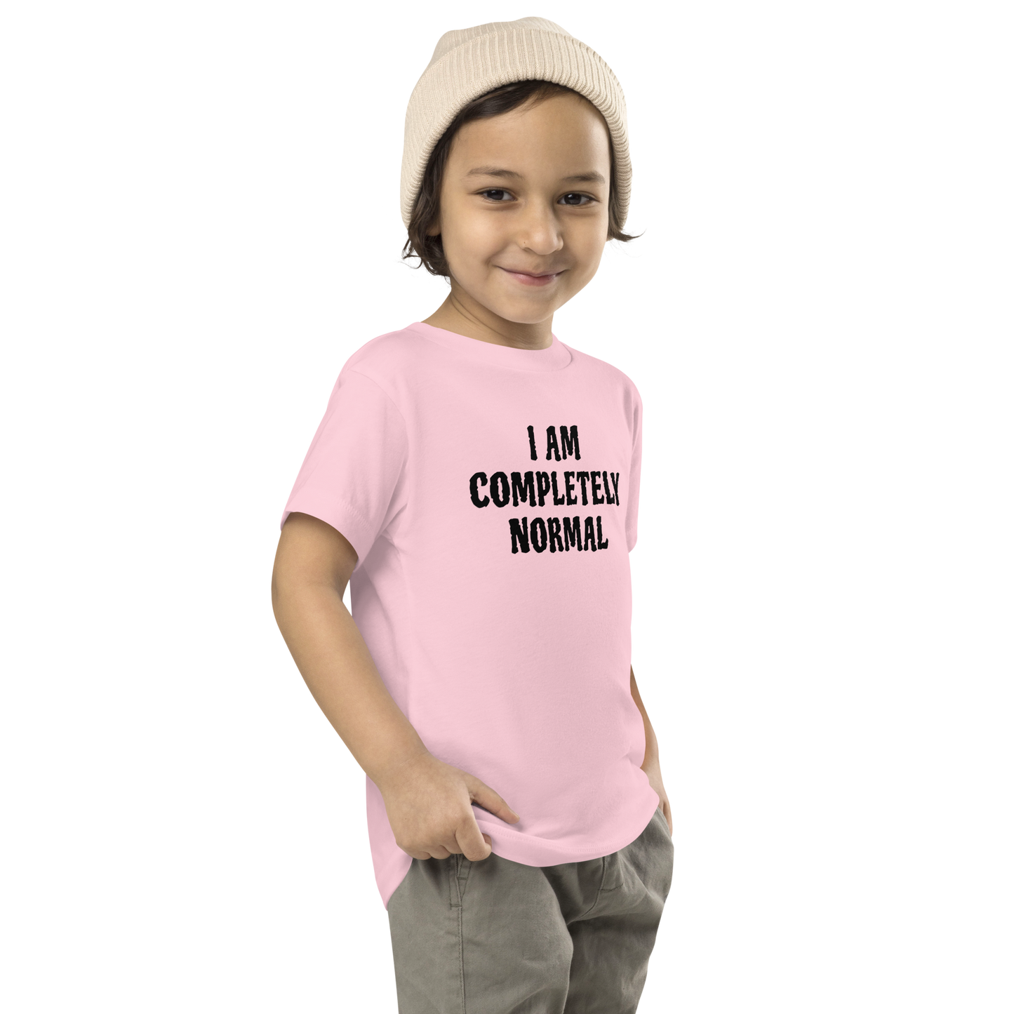 "I am completely normal" printed on a pink toddler short sleeve tee worn by a male who is also wearing a knit cap