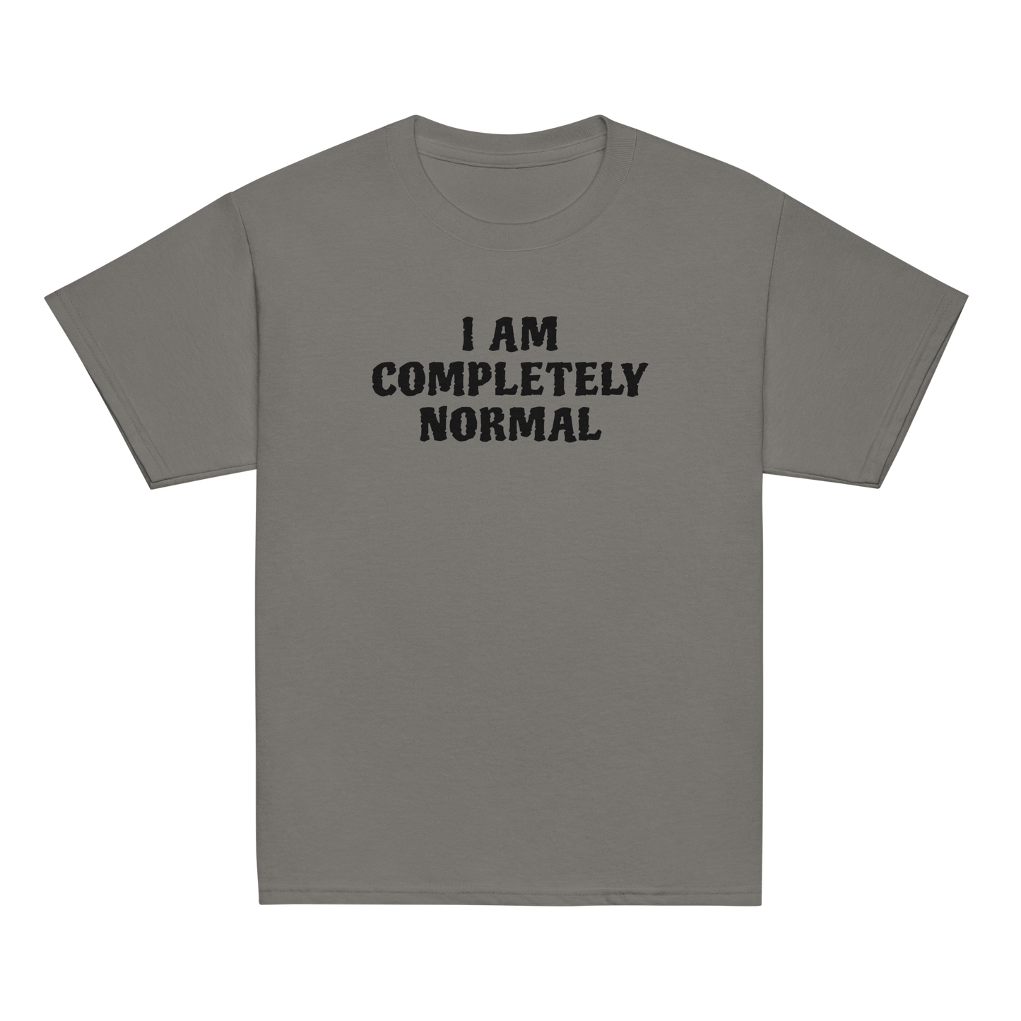 "I am completely normal" printed on a charcoal youth classic tee laying on a flat surface