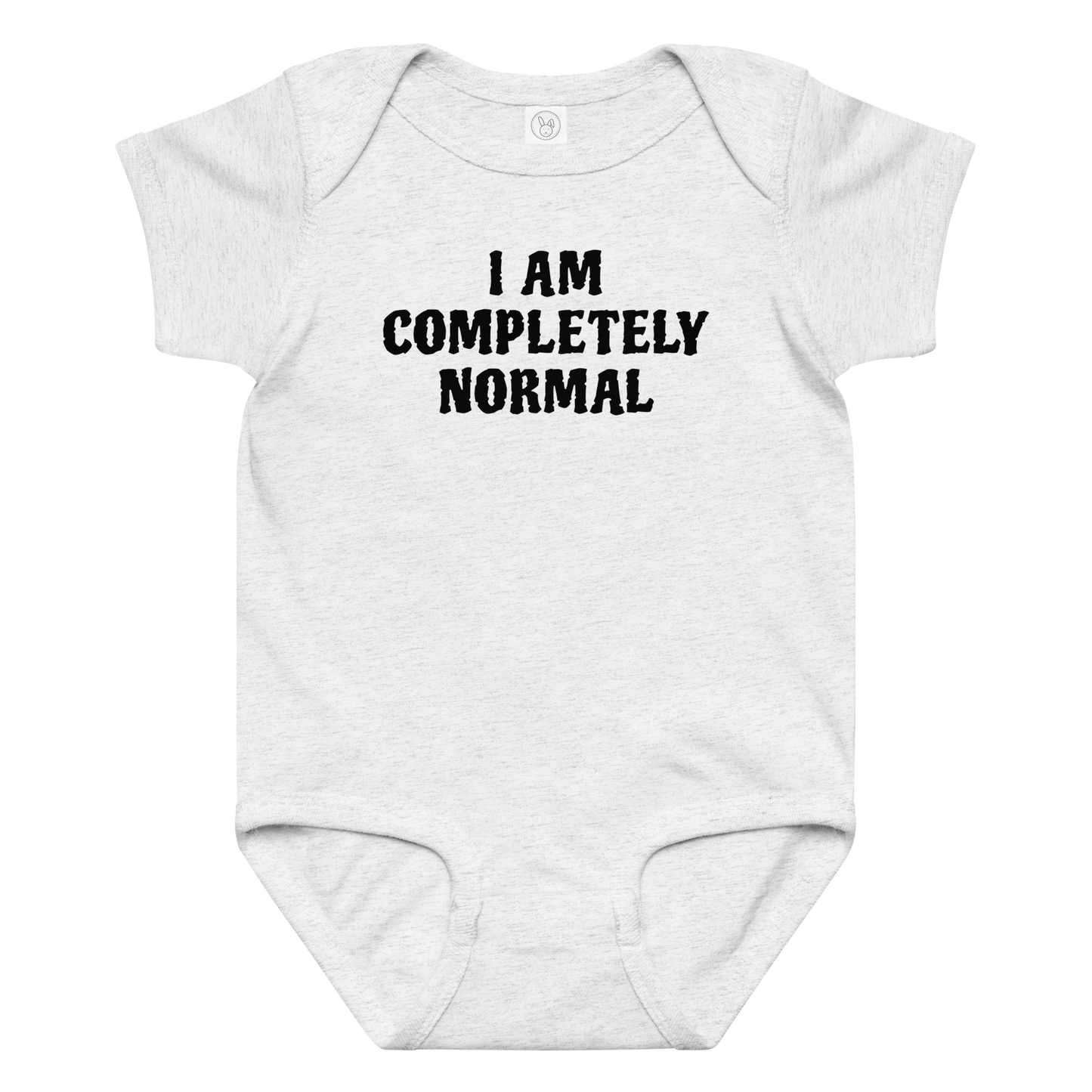 "I am completely normal" printed on a ash baby jersey bodysuit laying on a flat surface amongst other clothes