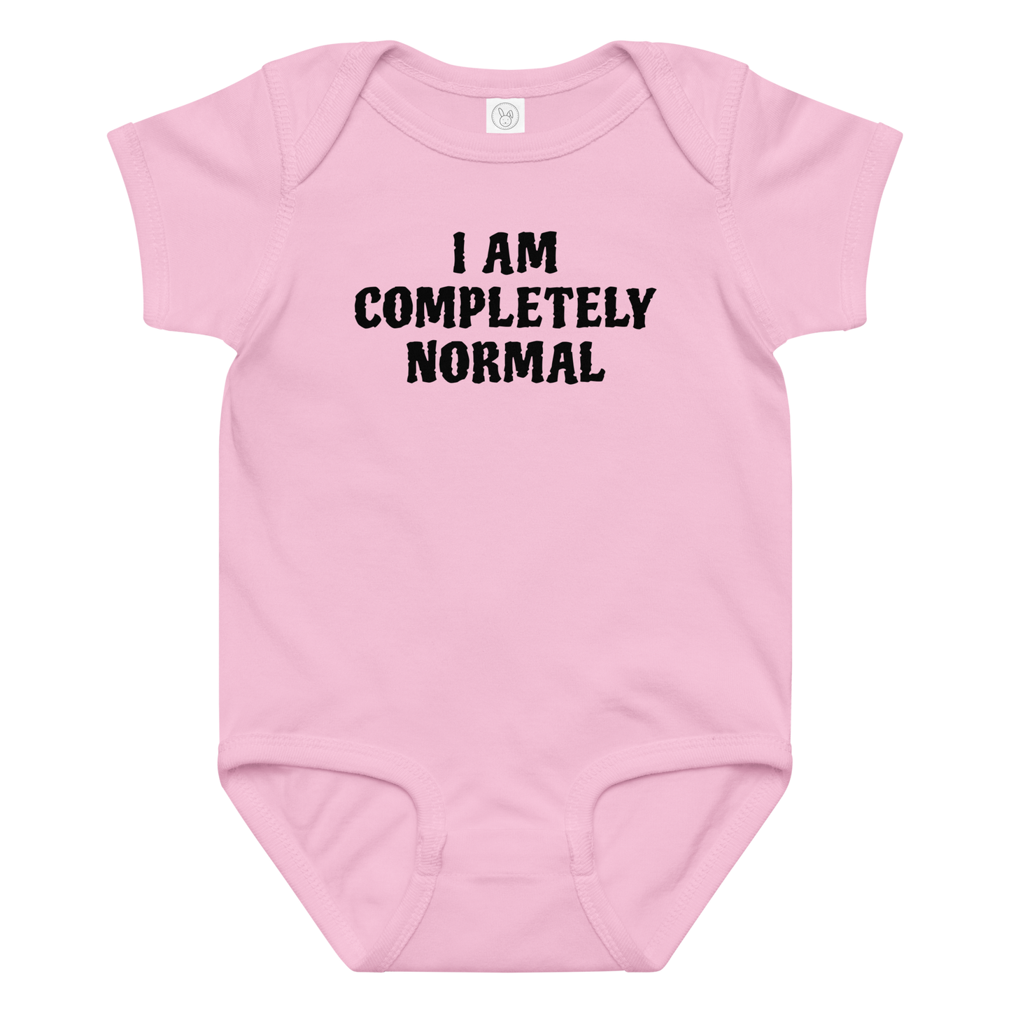 "I am completely normal" printed on a pink baby jersey bodysuit laying on a flat surface amongst other clothes
