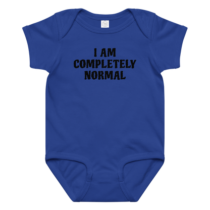 "I am completely normal" printed on a royal baby jersey bodysuit laying on a flat surface amongst other clothes