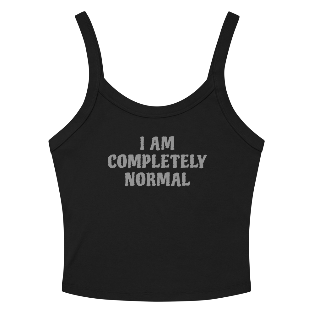 "I am completely normal" printed on a solid black blend women's micro-rib tanktop laying on a flat surface amongst sunglasses and shorts