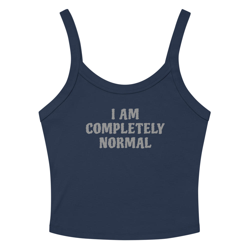 "I am completely normal" printed on a solid navy blend women's micro-rib tanktop laying on a flat surface amongst sunglasses and shorts