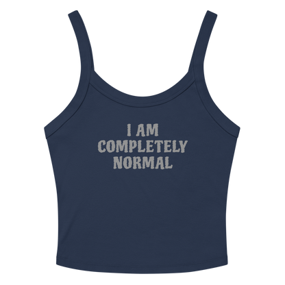 "I am completely normal" printed on a solid navy blend women's micro-rib tanktop laying on a flat surface amongst sunglasses and shorts