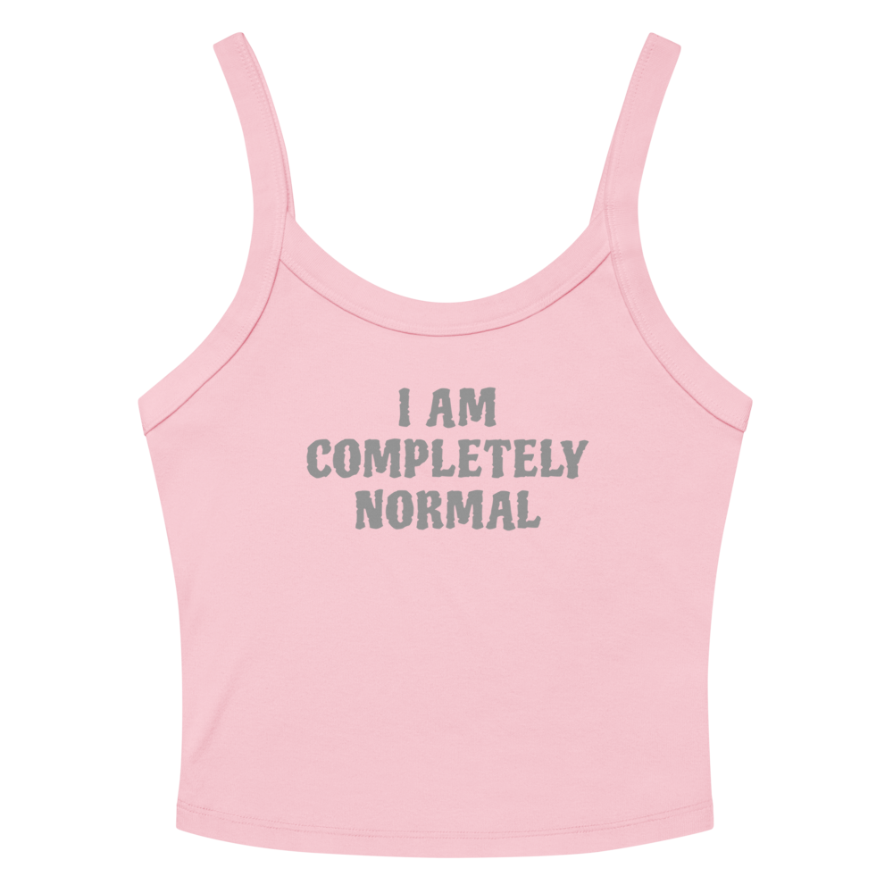 "I am completely normal" printed on a solid pink blend women's micro-rib tanktop laying on a flat surface amongst sunglasses and shorts