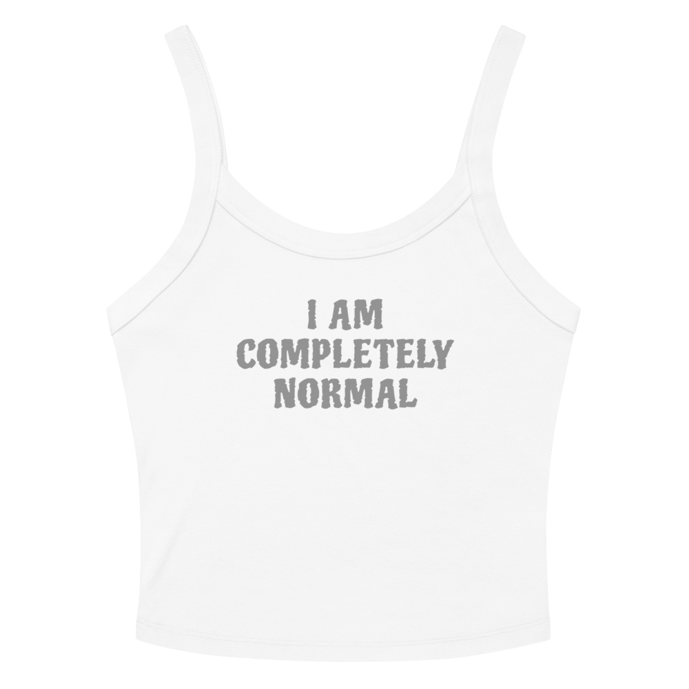 "I am completely normal" printed on a solid white blend women's micro-rib tanktop laying on a flat surface amongst sunglasses and shorts