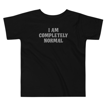 "I am completely normal" printed on a black toddler short sleeve tee laying on a flat surface